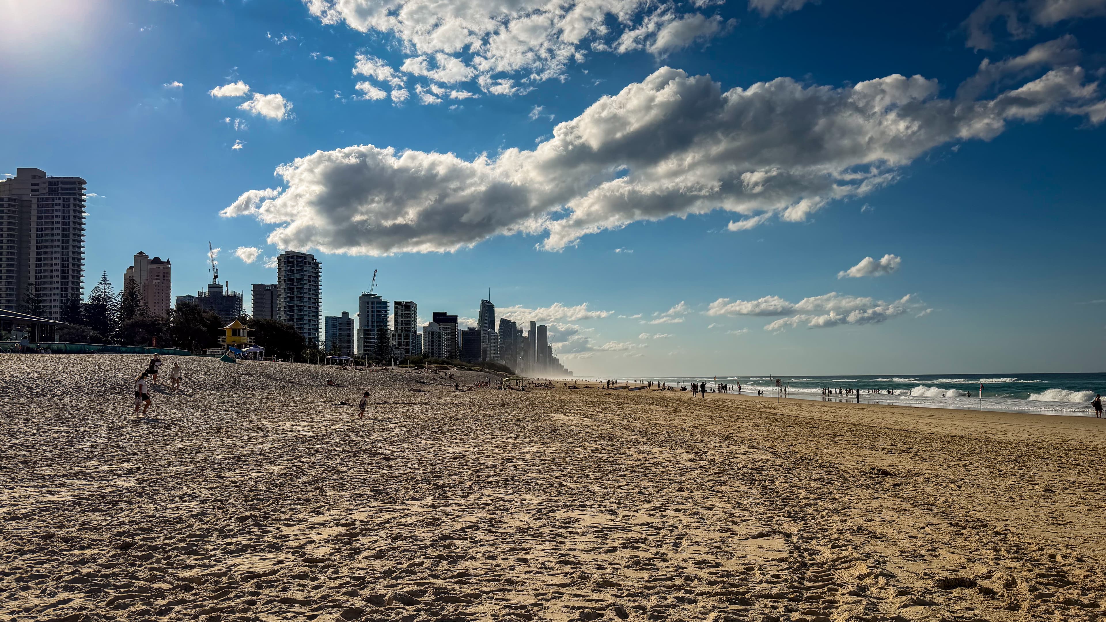 Late afternoon at Kurrawa Beach in Broadbeach, looking north along the sand toward the Gold Coast skyline.
