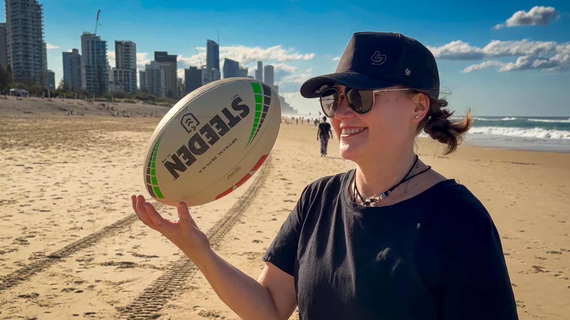 Sid Biggs of Seabreeze Bodywork balancing a football at the beach on the Gold Coast.